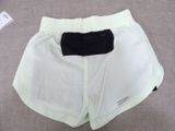 a close up of a pair of white shorts on a bed