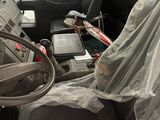 a bus with a covered seat and a laptop on it
