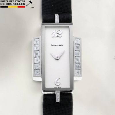 a close up of a watch on a white surface