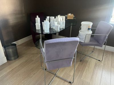 a glass table with a lot of bottles of lotion on it