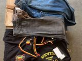 Plusieurs paires de jeans sont empilées sur une palette en bois