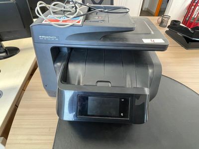 a printer sitting on top of a desk next to a monitor