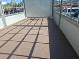 a shadow of a person on the ground in a parking lot