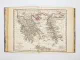an old book with a map of the world on it