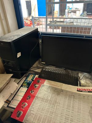 a desk with a computer monitor and a keyboard on it