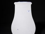 a white vase that is sitting on a black surface