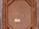 an old picture frame with a piece of paper on the bottom of it