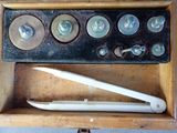 a wooden box with some screws and screws in it
