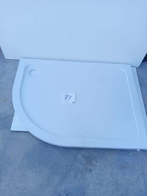 a white toilet with a lid that is sitting on the ground