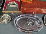 a lot of silverware on a table with a brown case