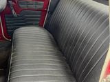 a seat in the back of a car that is red and black