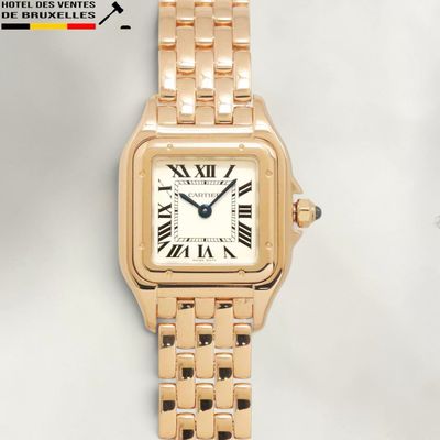 an image of a gold wrist watch with roman numerals on it