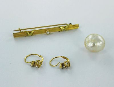 two pairs of earrings and a pin with a pearl on it