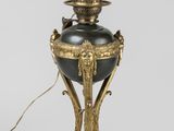 an image of a black and gold lamp on a white background