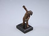 bronze statue of a man on a marble base with his arms raised