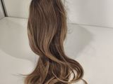 a close up of a wig on a table with a mirror in the background