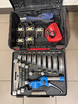a tool box with tools in it sitting on the floor
