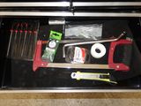 a tool box with tools inside of it on the floor
