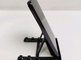 a cell phone sitting on a stand on a table