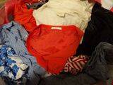 a pile of clothes that is sitting in a suitcase