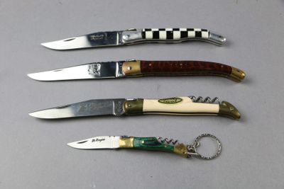 four different types of knives are lined up on a table