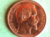 a close up of a penny on a green surface