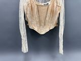 an image of a white shirt hanging on a hanger on a wall