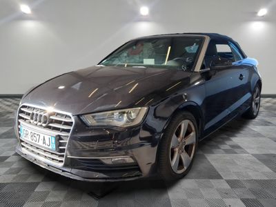 the audi audi is parked in a garage with a checkered floor