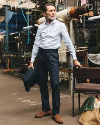 a man that is standing next to a bench