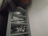 a drawer with silverware and utensils inside of it