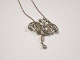 an antique silver filigree necklace with a dangling pendant