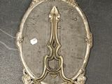 a mirror with a clock on it on a table