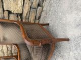 two chairs that are sitting next to a stone wall