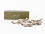 a group of four silver birds sitting next to a box