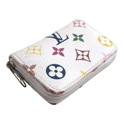 a close up of a white wallet with multicolored designs on it