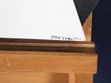 a piece of paper sitting on top of a wooden table
