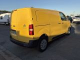 a yellow van parked in a parking lot with other vehicles