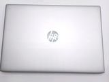 a white laptop with a hp logo on the screen
