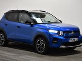 a blue suv parked in a room with a checkered floor