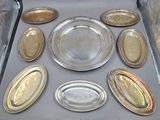 many silver plates in a box on a table