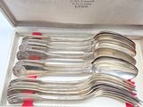 silverware in a silver box with red handles and red handles
