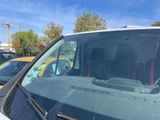 a car that has a broken windshield in the back of it