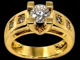 a close up of a gold ring with a diamond in the center