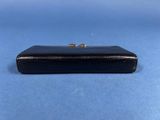 a small black box with a gold ring on top of it