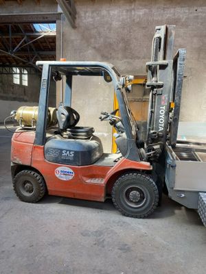 a fork lift truck parked in front of a building