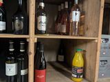 many bottles of wine sitting on a shelf in a room