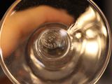 a person holding a wine glass in their hand