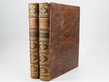 a pair of old books sitting on top of each other