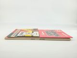 two books sitting on top of each other on a white surface