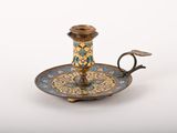 an antique brass candle holder with a blue and yellow design